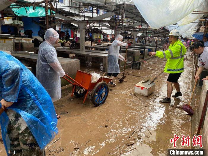圖為7月26日，暴雨引發(fā)的洪水過(guò)境后，重慶萬(wàn)州區(qū)分水鎮(zhèn)政府干部職工及志愿者清掃淤泥和垃圾?！　≈貞c萬(wàn)州區(qū)委宣傳部供圖 攝